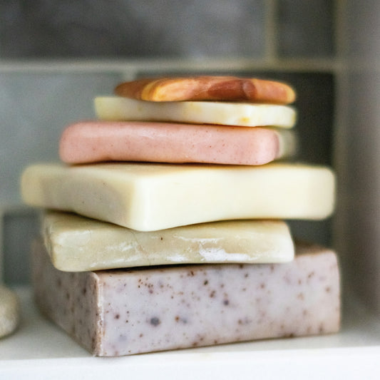 stack of different colored handmade soaps