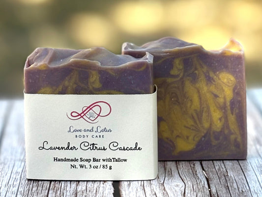 Two handmade soap bars with a visible label on a wooden surface